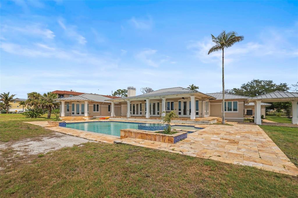 1721 Gulf Road Tarpon Springs, FL 34689 - Photo 56 of 96 a front view of a house with a yard and potted plants