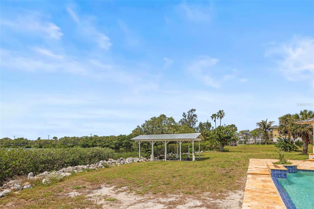 1721 Gulf Road Tarpon Springs, FL 34689 - Photo 57 of 96 a view of a lake with a big yard and large trees