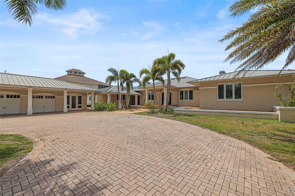 1721 Gulf Road Tarpon Springs, FL 34689 - Photo 60 of 96 a front view of a house with a garden and yard