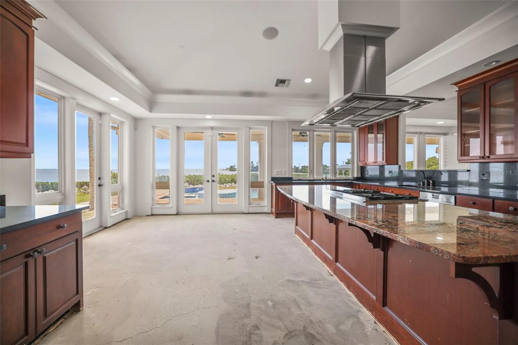 1721 Gulf Road Tarpon Springs, FL 34689 - Photo 10 of 96 a large living room with stainless steel appliances granite countertop a large kitchen counter top a stove and a sink with couches