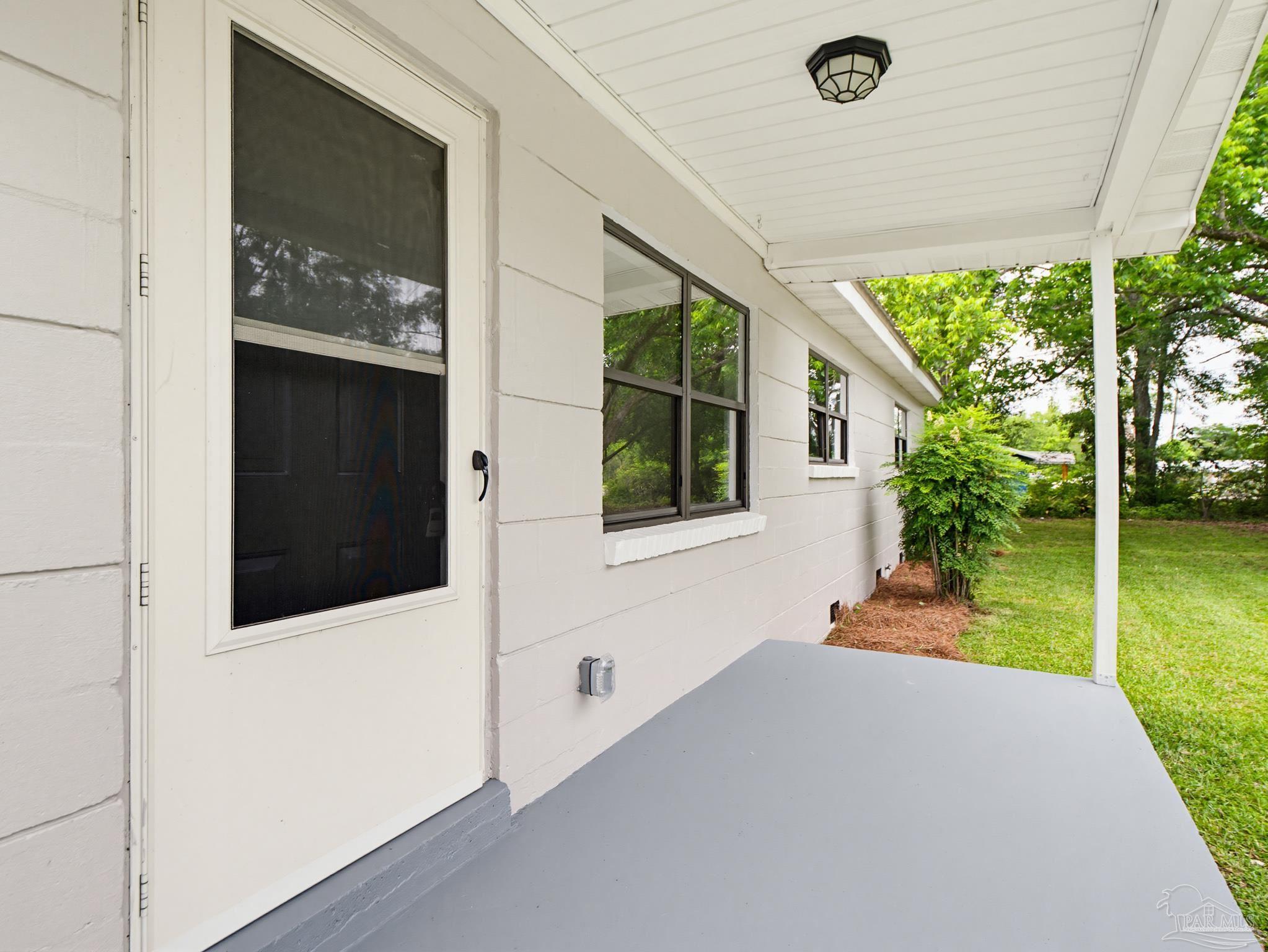 125 Madrid Road Cantonment, FL 32533 - Photo 2 of 16 a front view of a house with a yard
