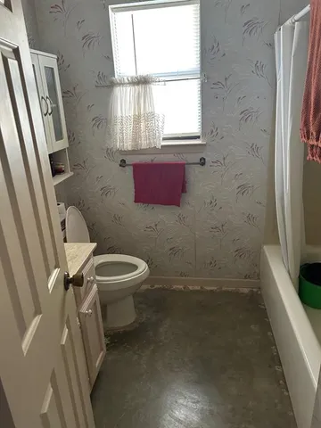 a bathroom with a toilet sink and a shower