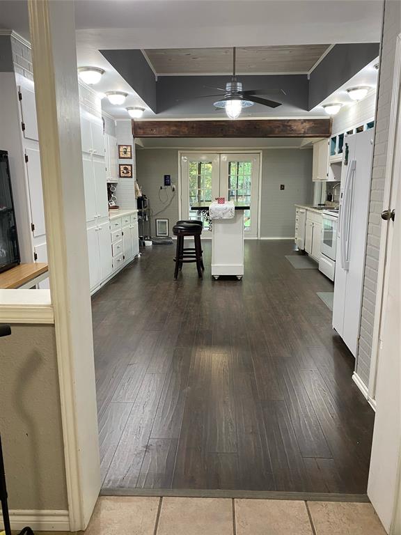 15415 Thunder Road Terrell, TX 75161 - Photo 7 of 21 Kitchen featuring an abundance of white cabinetry, new flooring, a moveable kitchen island, wood tile ceiling insert and a ceiling fan