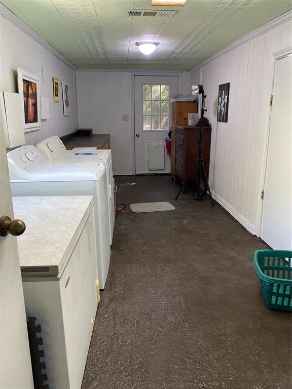 15415 Thunder Road Terrell, TX 75161 - Photo 9 of 21 Laundry area featuring washer and clothes dryer, room for a freezer and tons of storage. Access to backyard through end of laundry area.