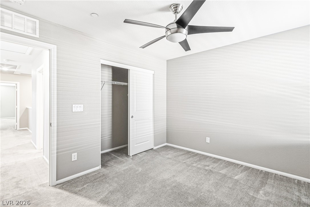 2834 Turnstone Ridge Street Henderson, NV 89044 - Photo 14 of 22 Plush carpeting and an integrated closet define this modern bedroom space.