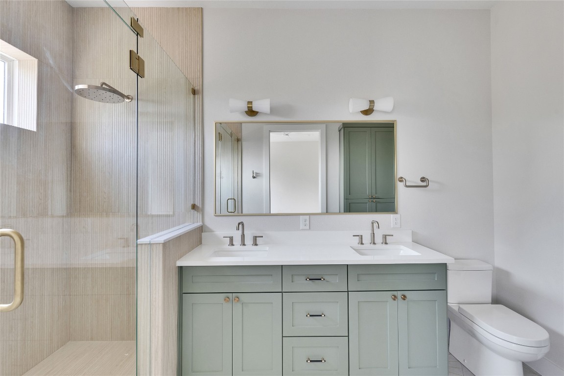 1937 East 38th 1/2 Street, Unit A Austin, TX 78723 - Photo 16 of 26 a bathroom with a sink double vanity and a shower