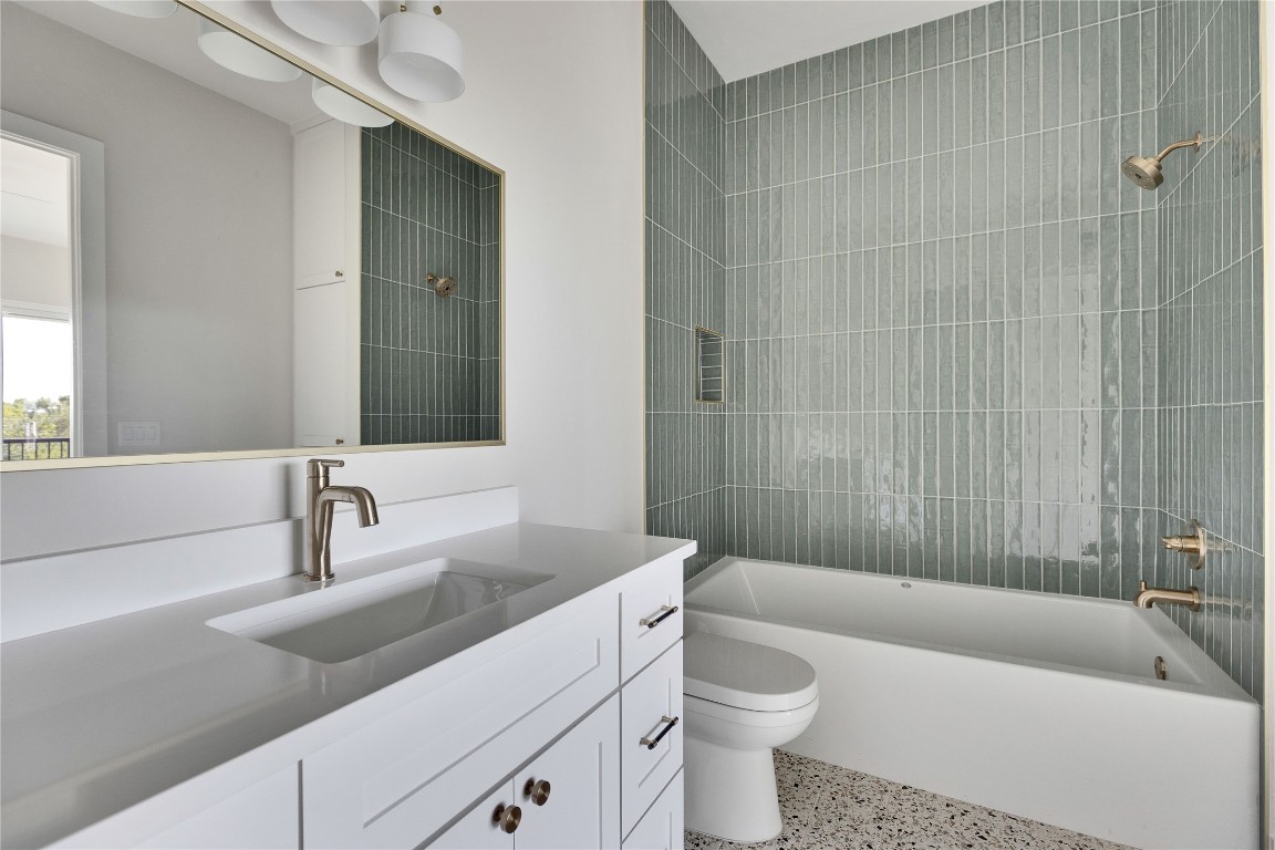 1937 East 38th 1/2 Street, Unit A Austin, TX 78723 - Photo 19 of 26 a bathroom with a sink a toilet and bathtub