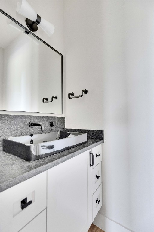 1937 East 38th 1/2 Street, Unit A Austin, TX 78723 - Photo 23 of 26 a bathroom with a granite countertop sink and a mirror