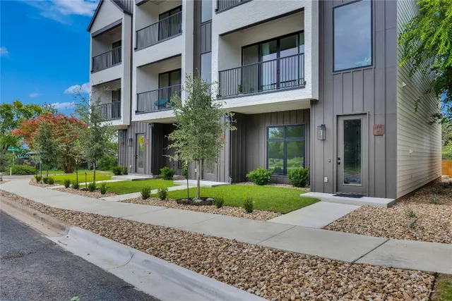 a view of a brick building next to a yard