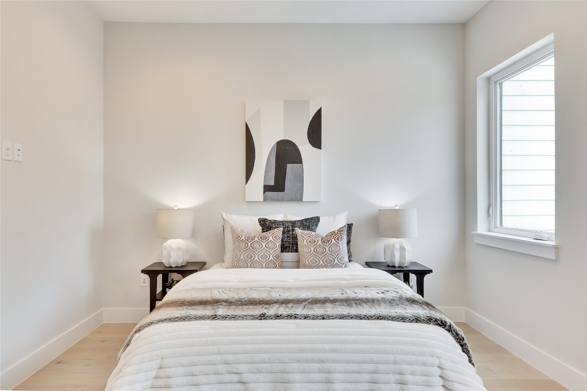 1937 East 38th 1/2 Street, Unit A Austin, TX 78723 - Photo 7 of 26 a bedroom with a bed and a window