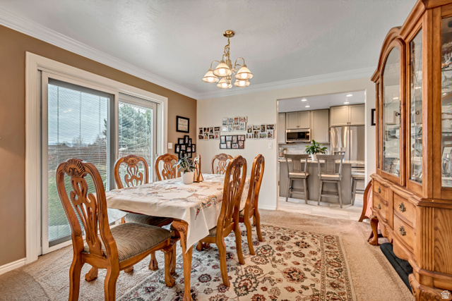 1697 North 500 West Mapleton, UT 84664 - Photo 8 of 50 Dining room featuring light carpet, hanging lights, and crown molding