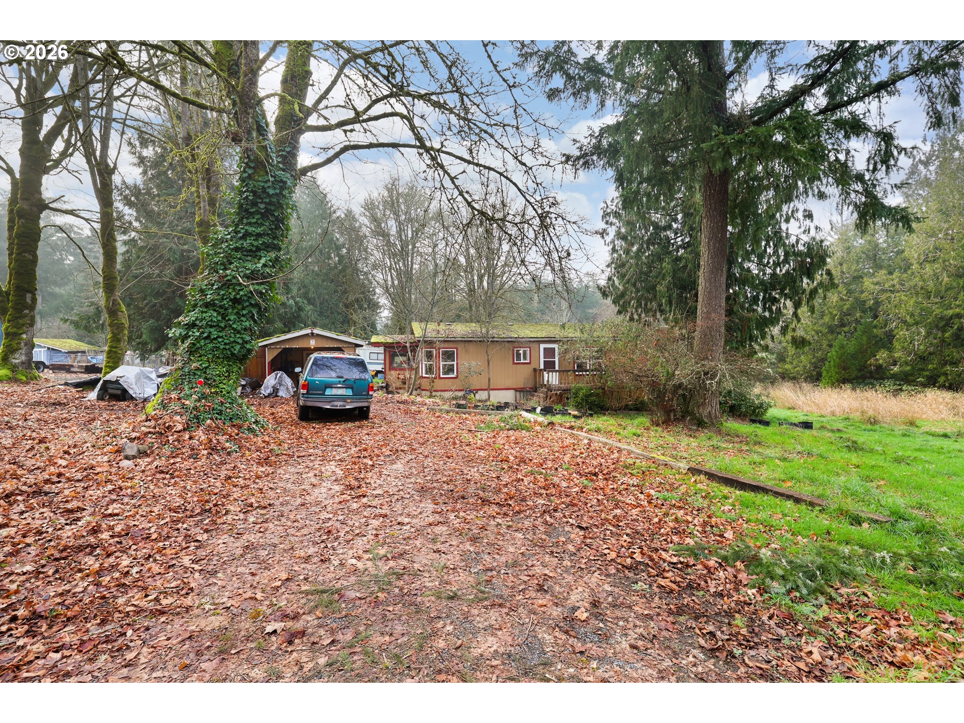 114 Shannon Lane Chehalis, WA 98532 - Photo 2 of 27 a view of a house with truck parked on a road near a forest