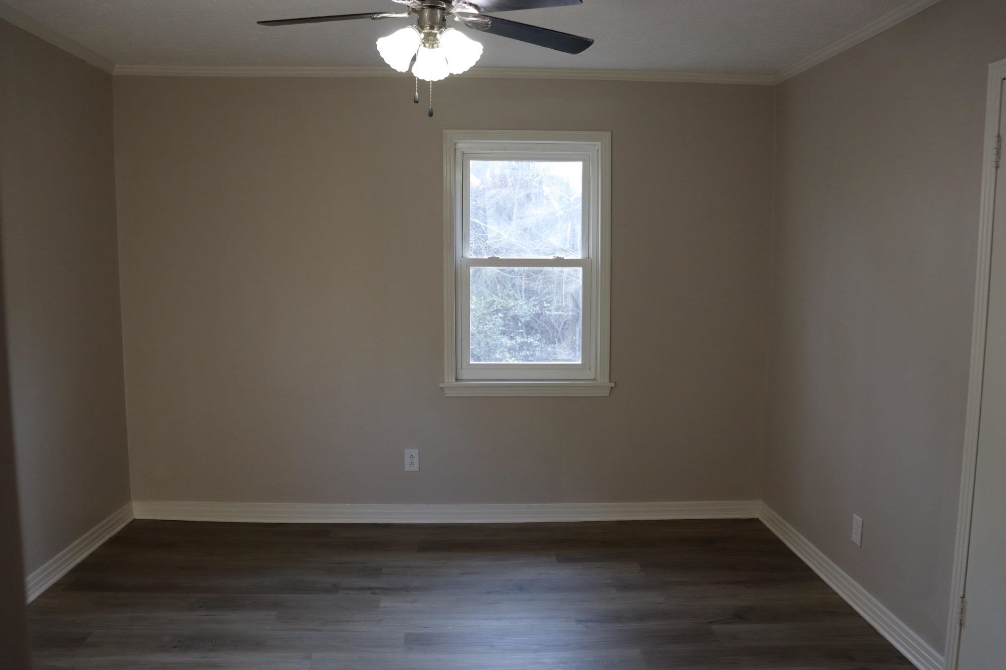2224 Feddie Davis Road Ramer, TN 38367 - Photo 23 of 24 an empty room with wooden floor and windows