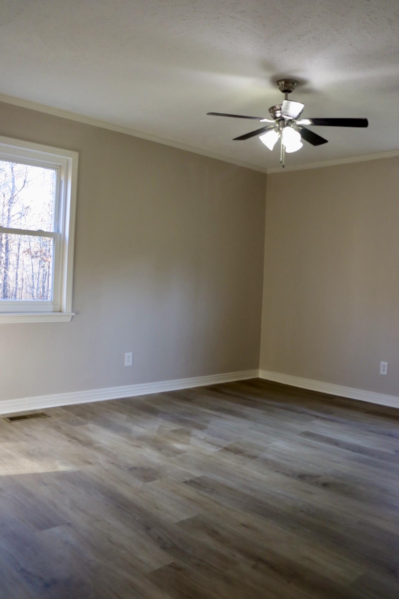 2224 Feddie Davis Road Ramer, TN 38367 - Photo 8 of 24 a view of an empty room with wooden floor and a window