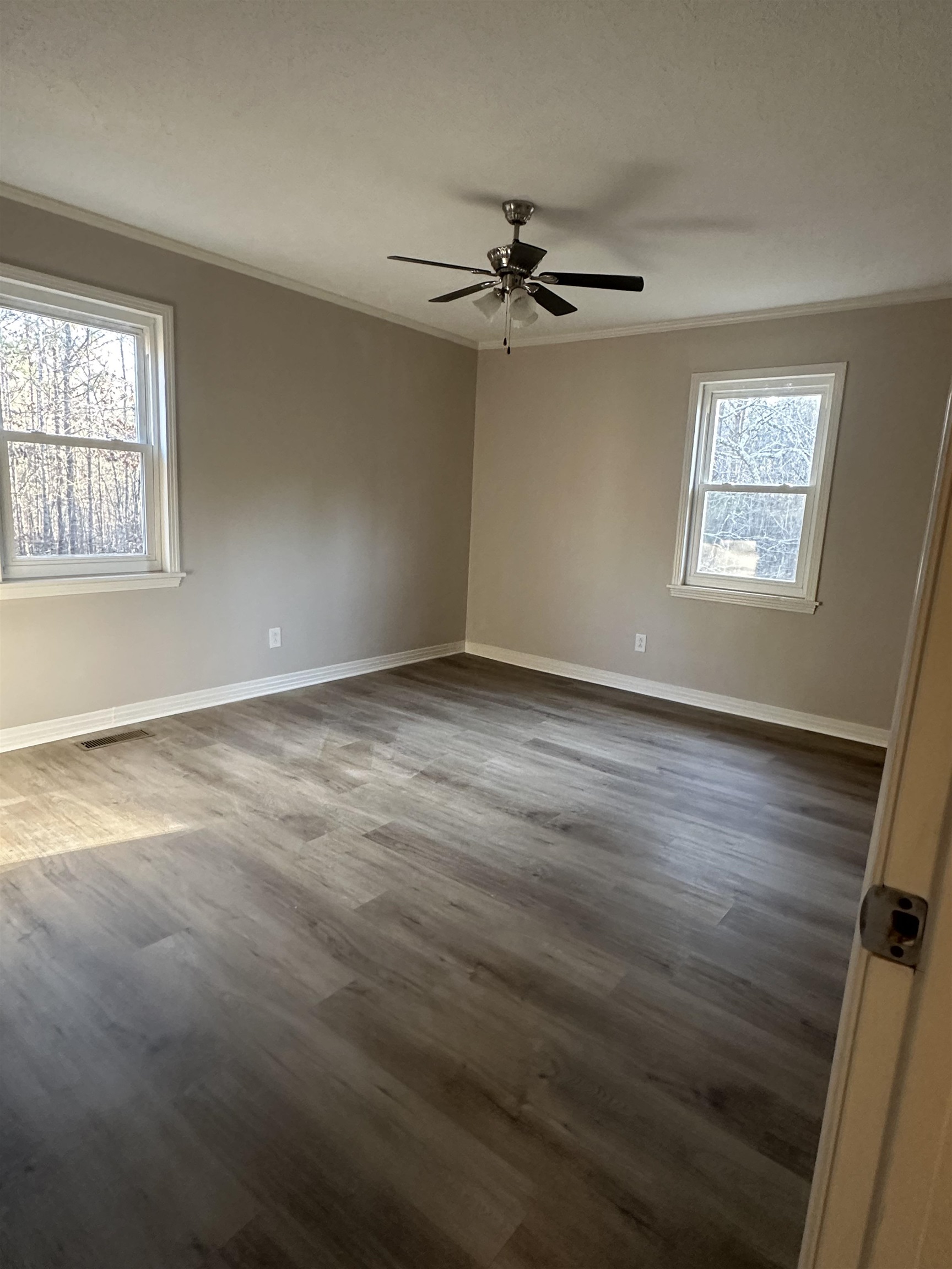 2224 Feddie Davis Road Ramer, TN 38367 - Photo 9 of 24 an empty room with wooden floor fan and windows