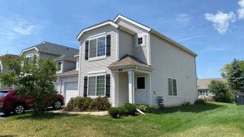 a front view of a house with a yard