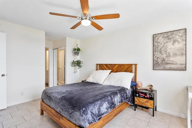 a bedroom with a bed and a painting on the wall