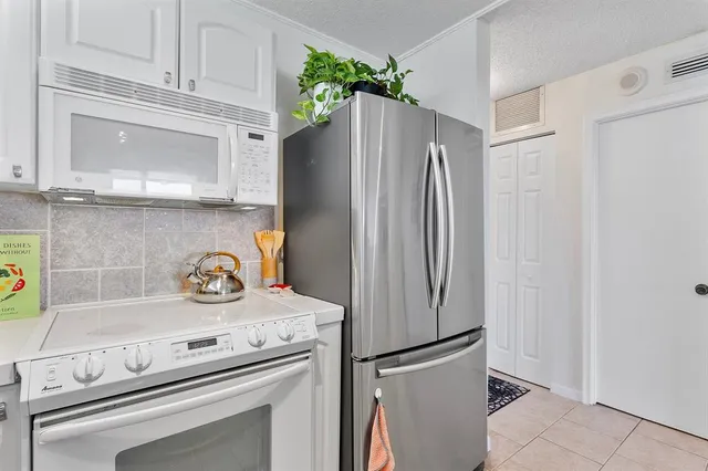 a kitchen with appliances and a refrigerator