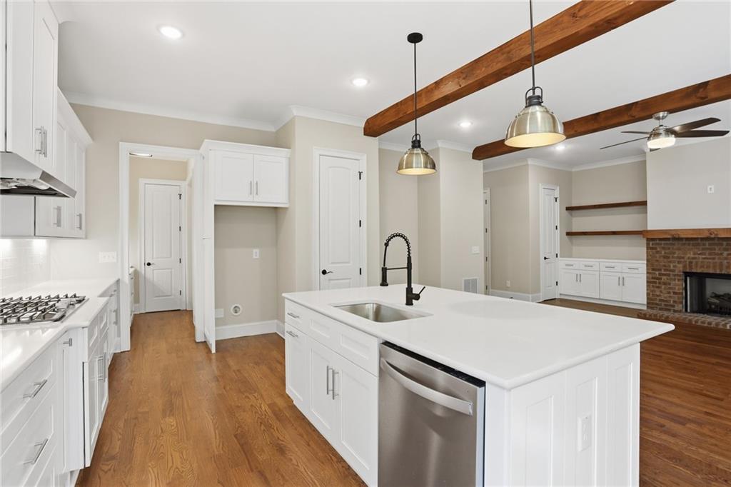 222 Trecastle Square, Unit 21 Canton, GA 30114 - Photo 9 of 33 a kitchen that has a sink a stove and a wooden floor