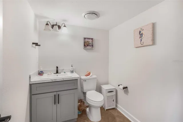 a kitchen with stainless steel appliances granite countertop white cabinets a sink dishwasher a stove and a refrigerator with wooden floor