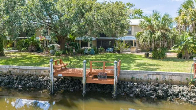 a view of a wooden deck and a yard with swimming pool