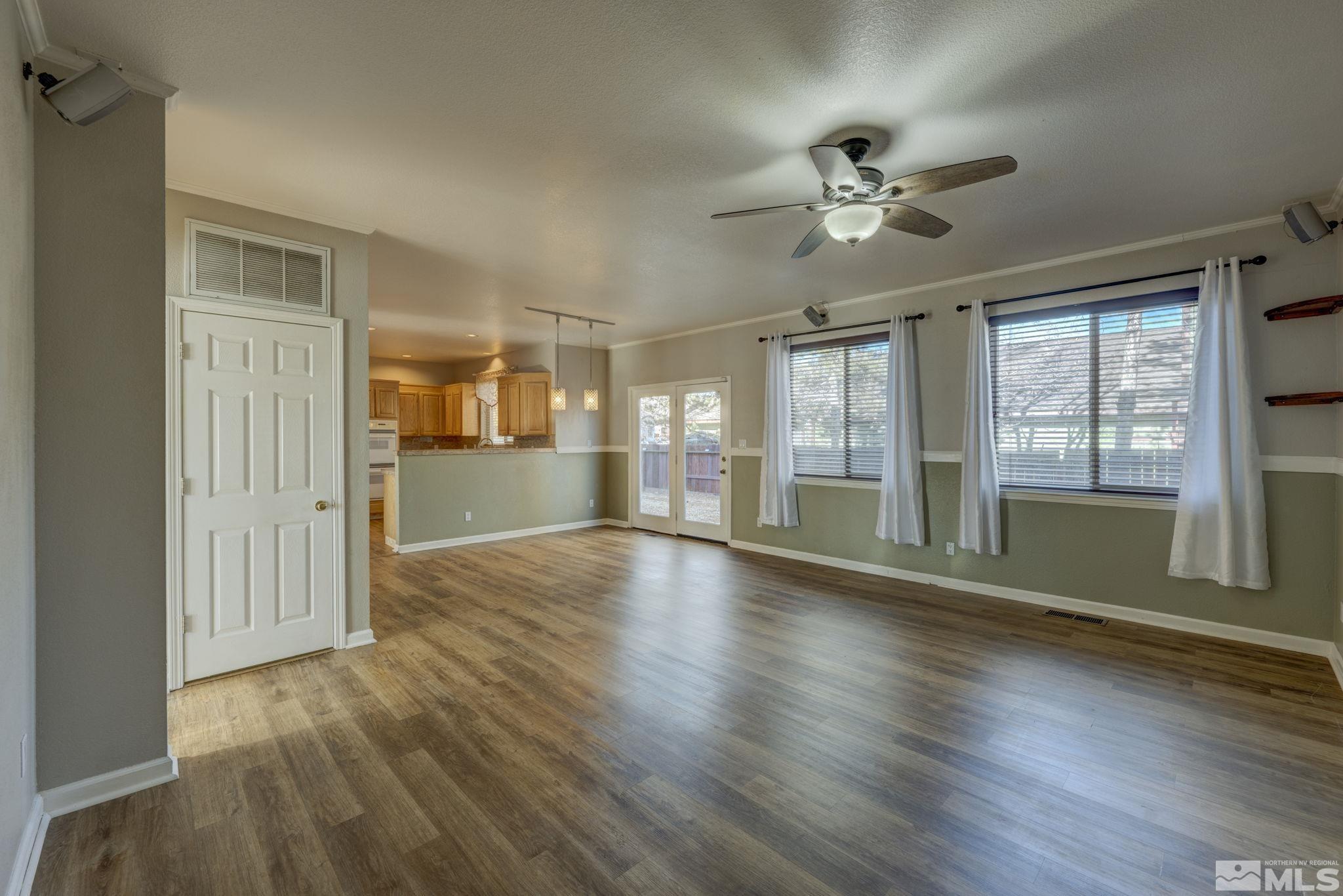 580 Creighton Way Reno, NV 89503 - Photo 12 of 40 a view of an empty room with wooden floor and a window