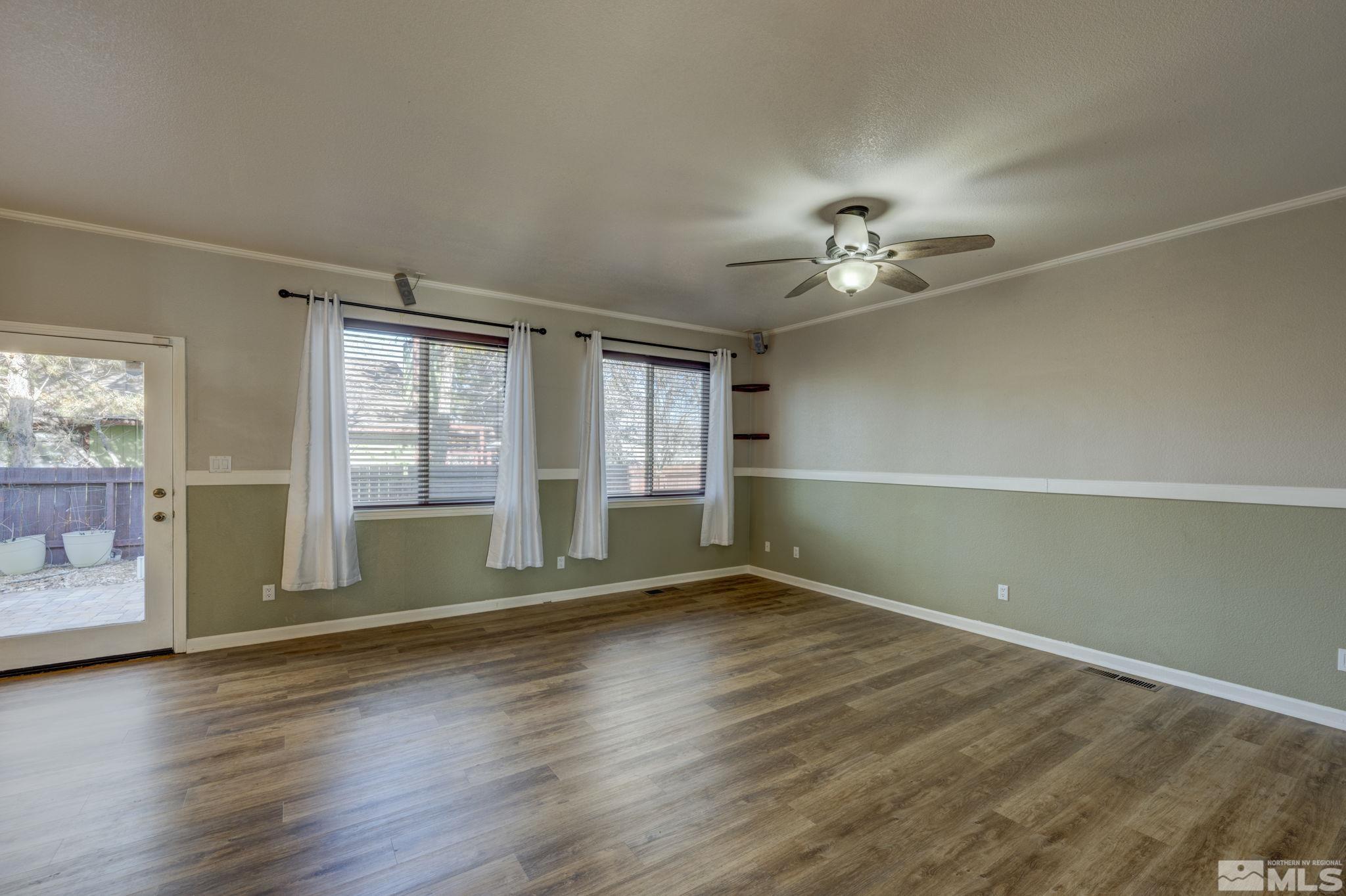580 Creighton Way Reno, NV 89503 - Photo 13 of 40 an empty room with wooden floor and windows