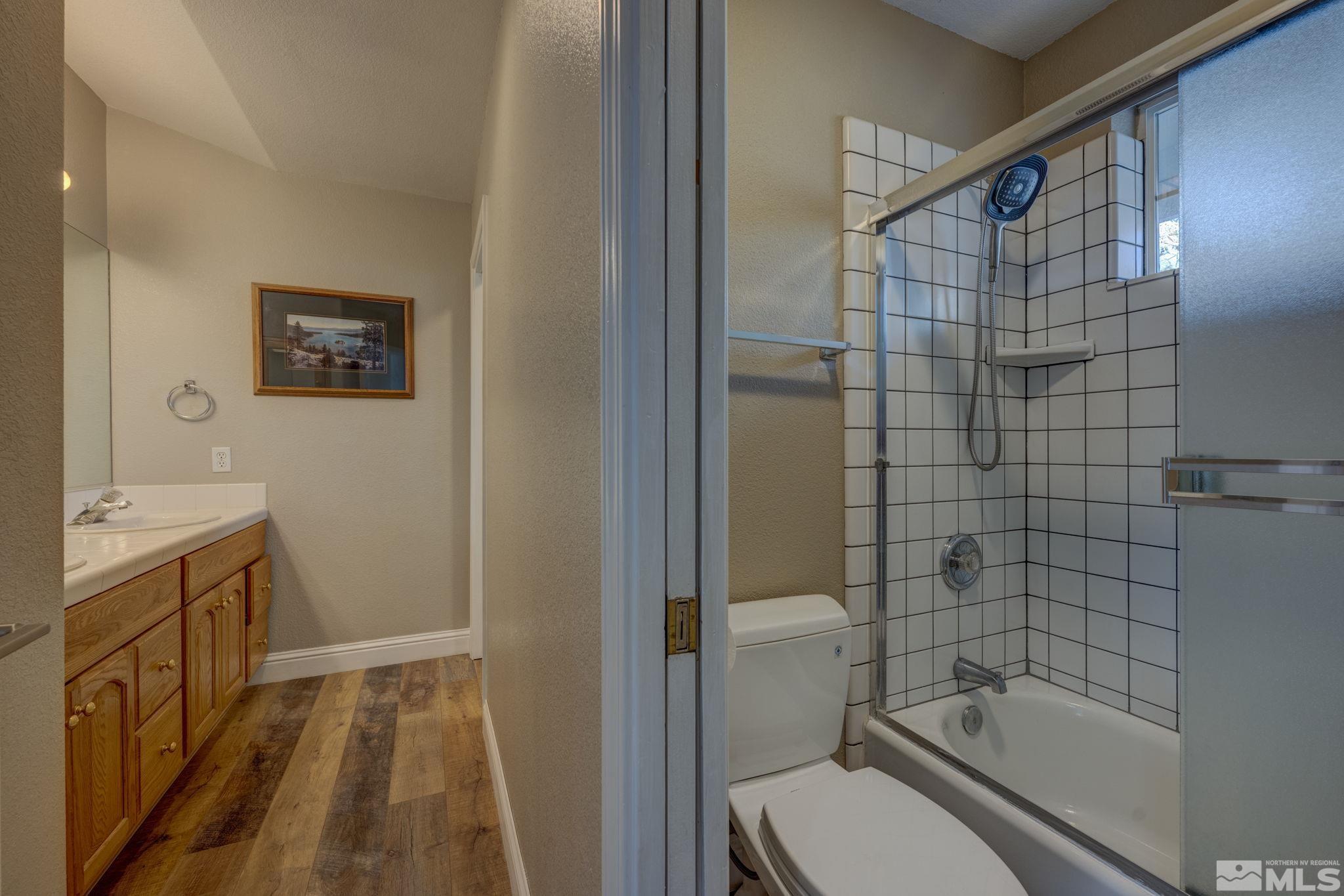 580 Creighton Way Reno, NV 89503 - Photo 28 of 40 a bathroom with a granite countertop sink toilet and shower