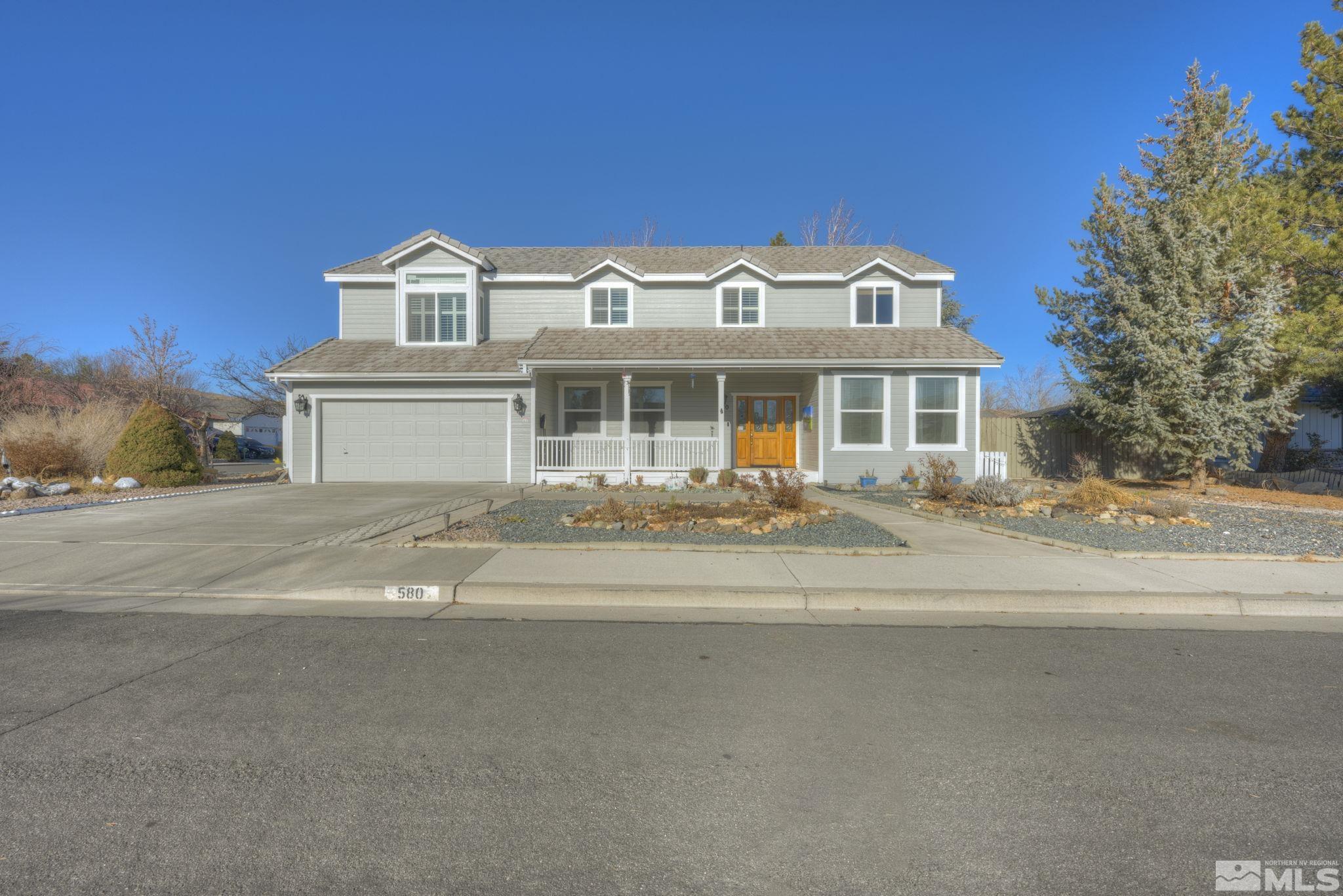 580 Creighton Way Reno, NV 89503 - Photo 4 of 40 a view of a white house with a large trees next to a road