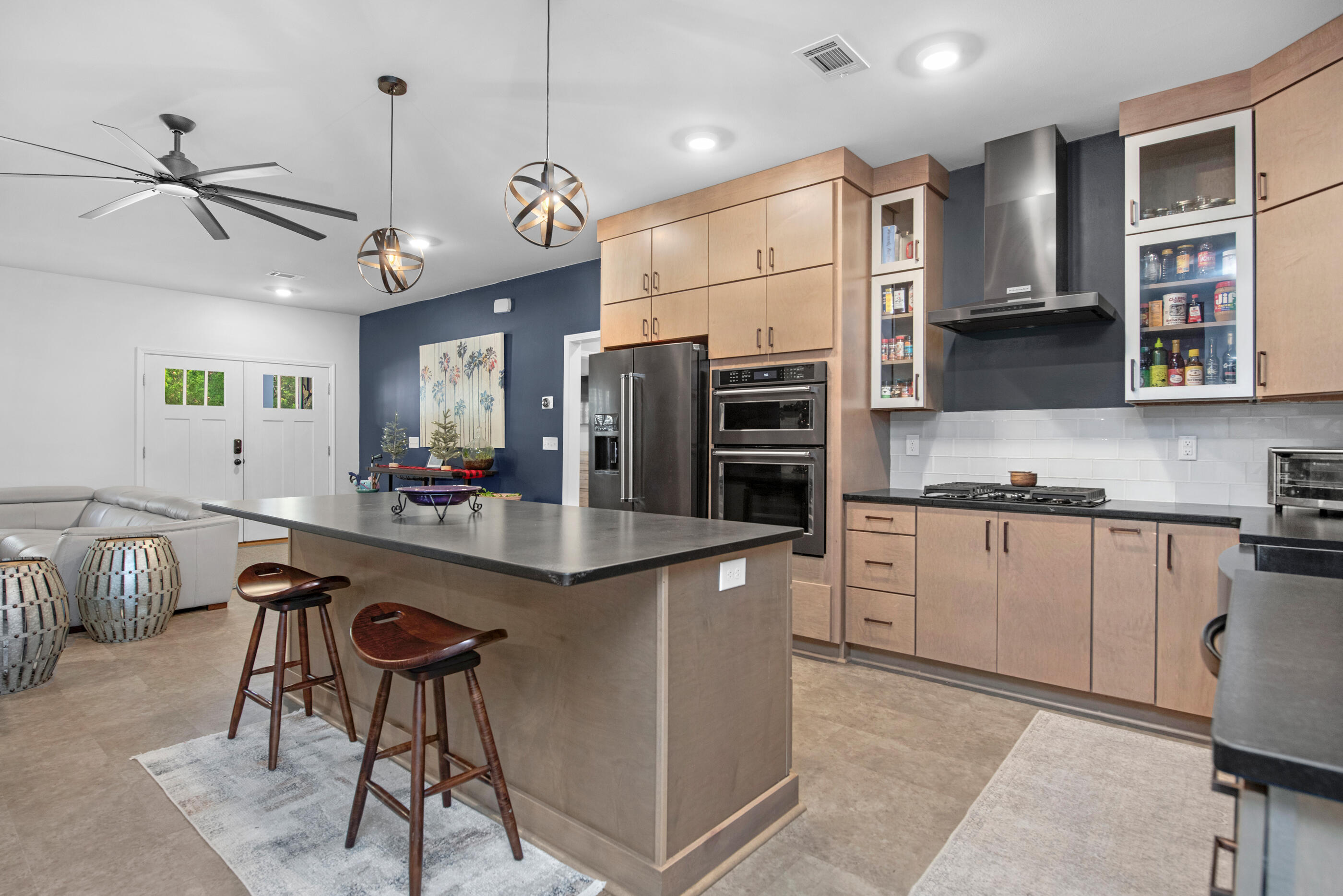 342 Eastern Street Freeport, FL 32439 - Photo 19 of 77 a kitchen with stainless steel appliances kitchen island granite countertop a table chairs in it and wooden floors