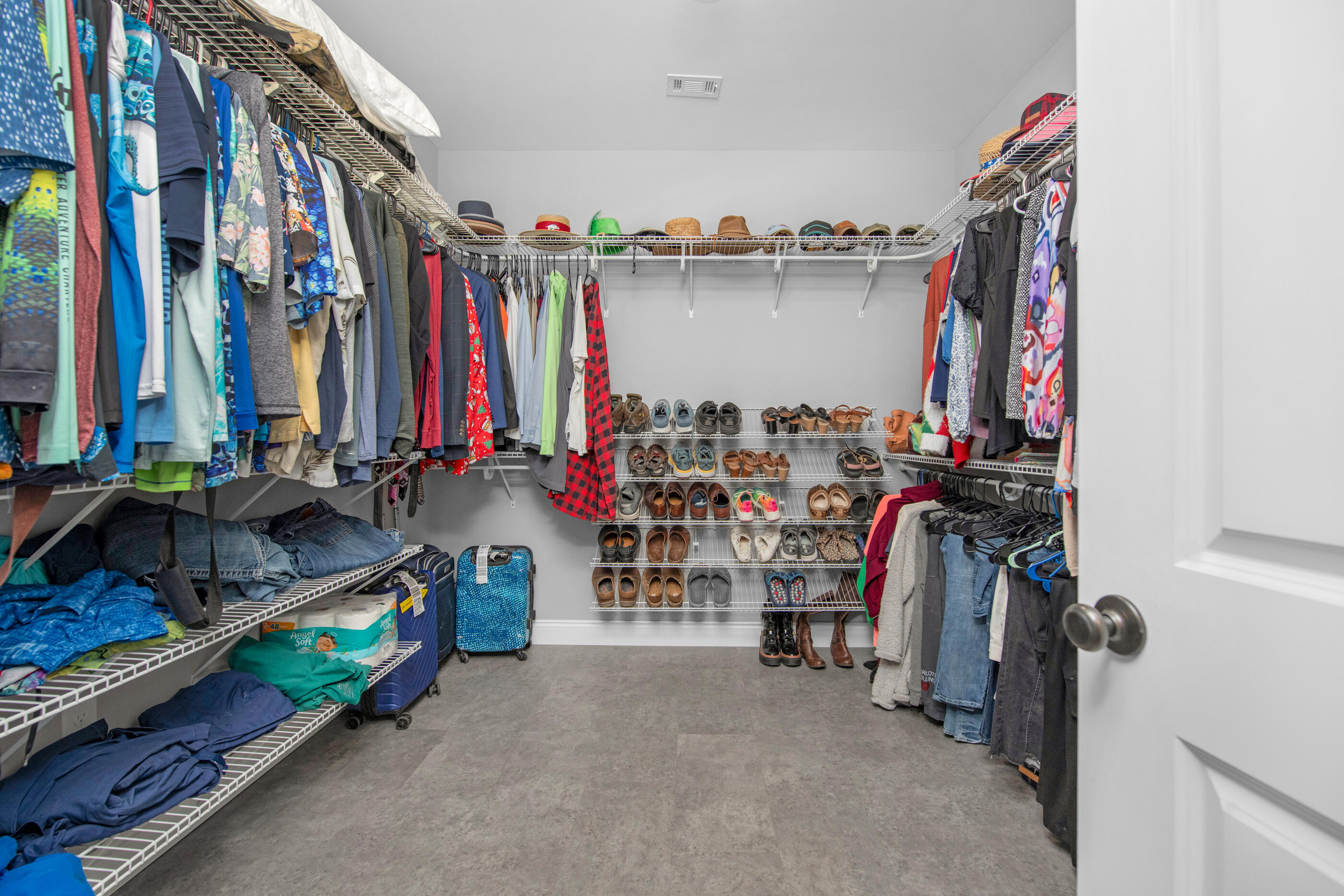 342 Eastern Street Freeport, FL 32439 - Photo 29 of 77 a view of walk in closet with clothes and shoes