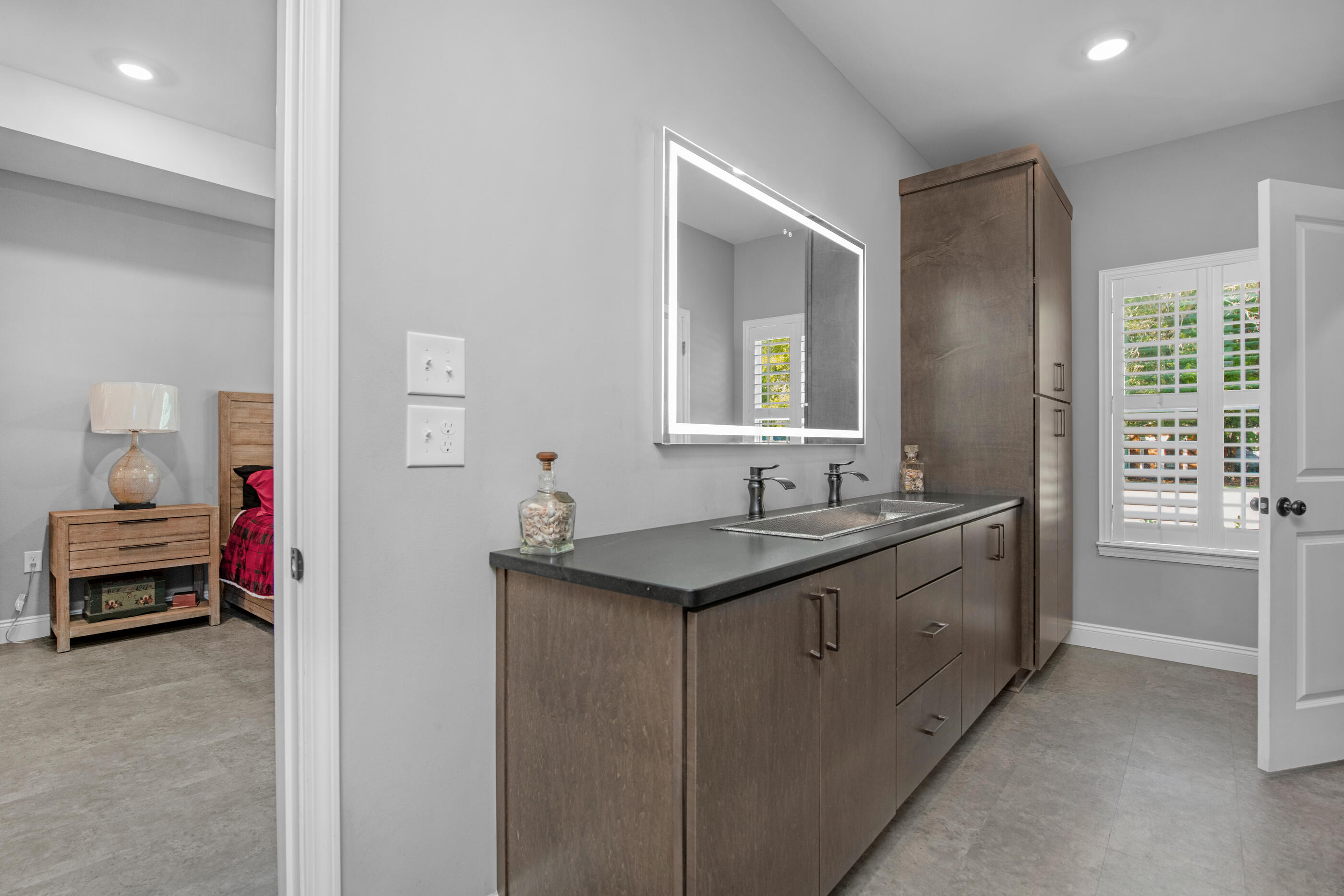 342 Eastern Street Freeport, FL 32439 - Photo 32 of 77 a en suite bathroom with a granite countertop sink and a mirror