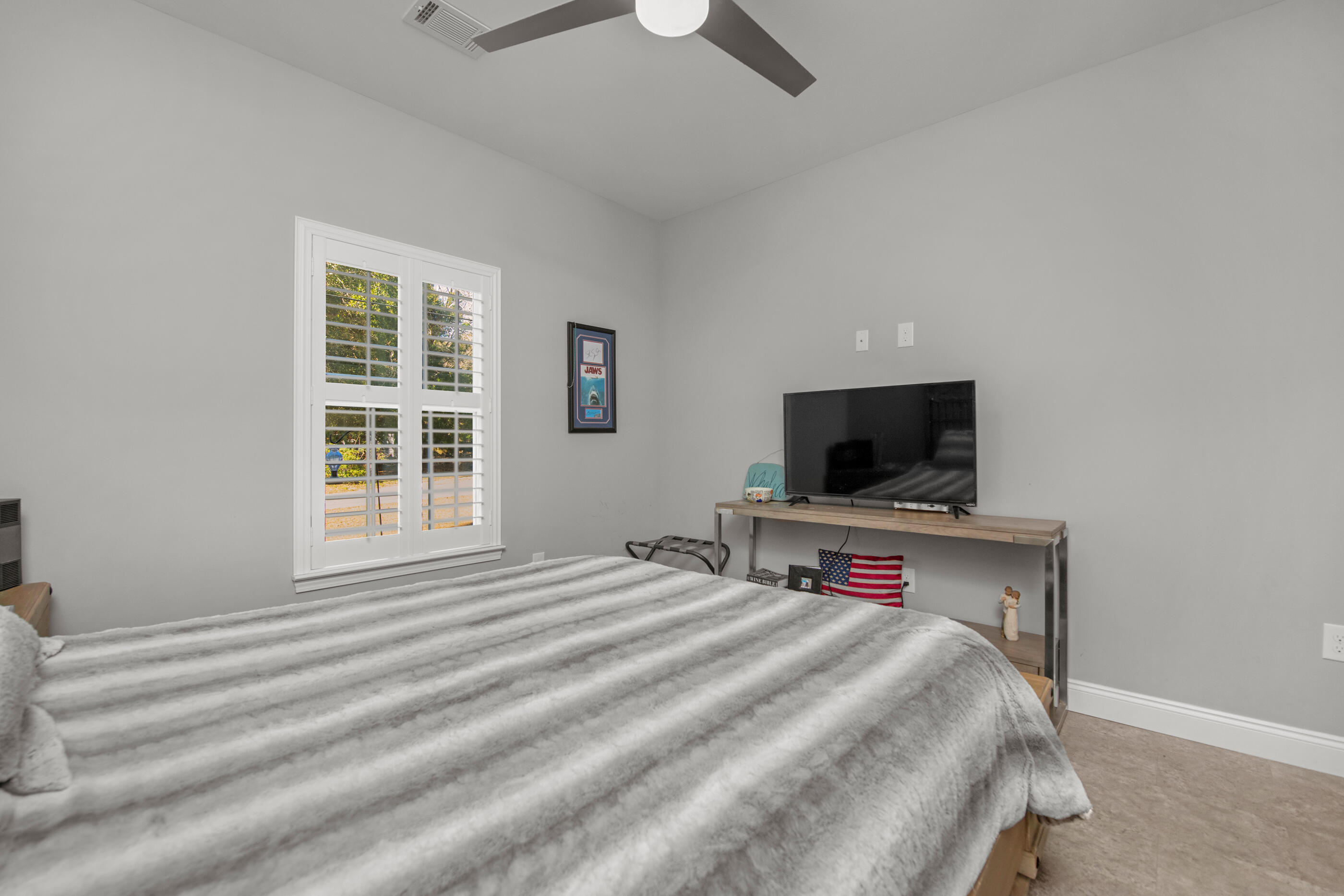 342 Eastern Street Freeport, FL 32439 - Photo 49 of 77 a bedroom with a bed and a flat screen tv