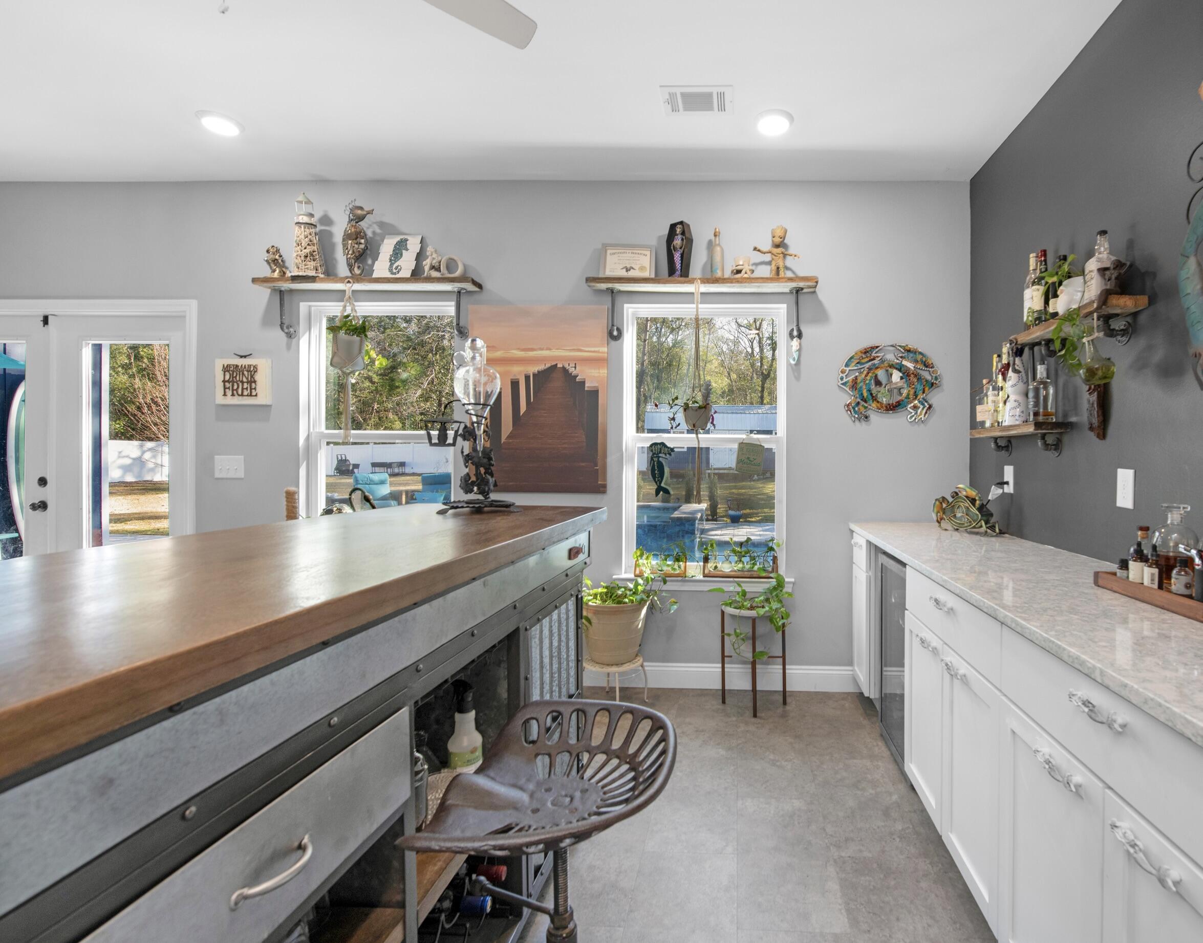 342 Eastern Street Freeport, FL 32439 - Photo 61 of 77 a kitchen with a sink cabinets and dining table