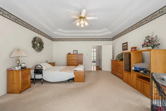 a bedroom with furniture and a flat screen tv