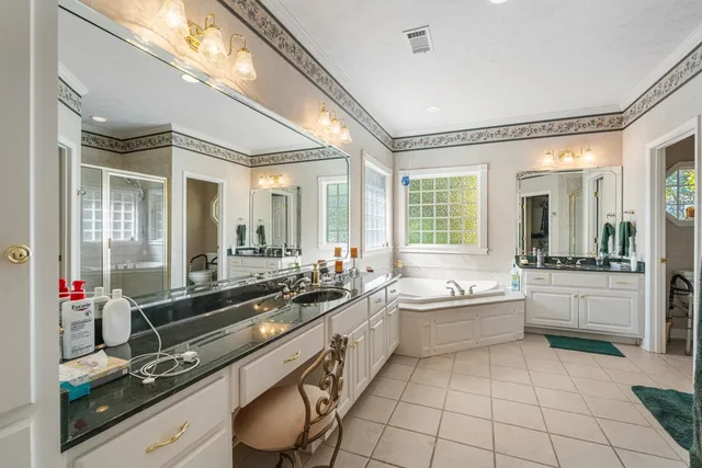 a large white kitchen with a large window