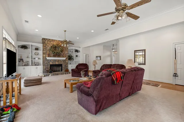 a living room with furniture a fireplace and a flat screen tv