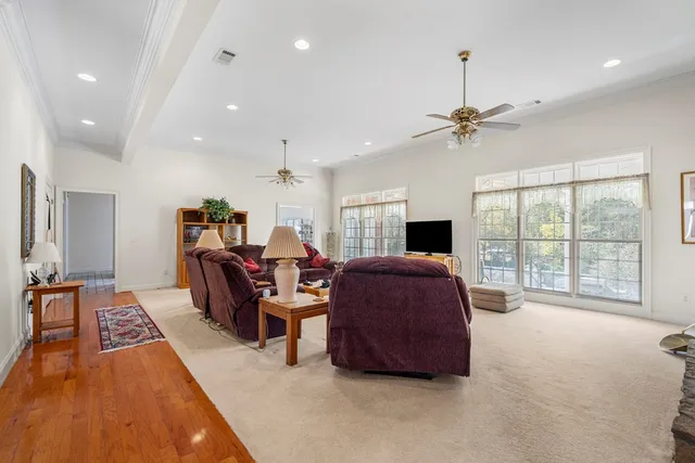 a living room with furniture fireplace and a large window
