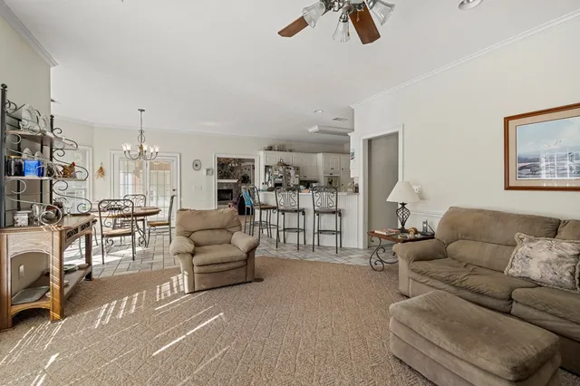 a living room with furniture and a chandelier