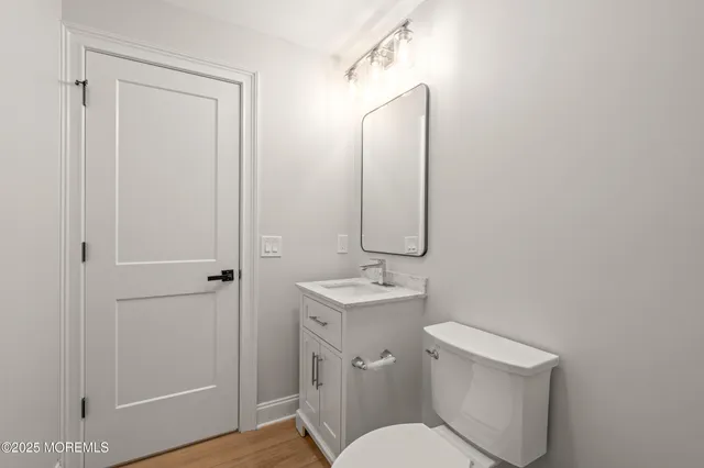 a bathroom with a toilet a sink and mirror