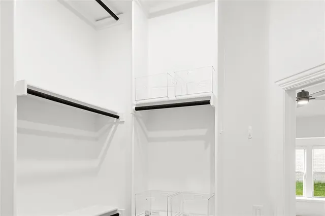 a white toilet sitting next to a white wall