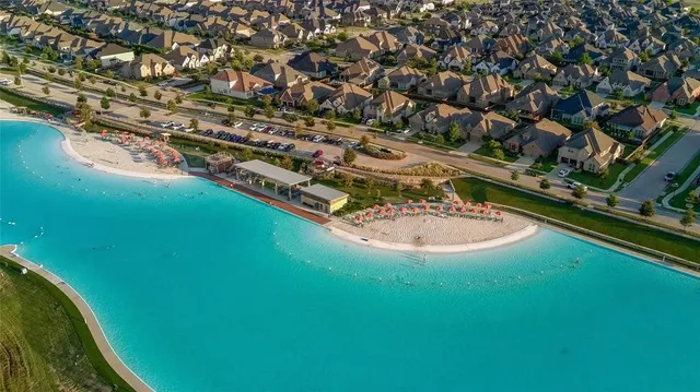 an aerial view of residential houses with outdoor space and swimming pool