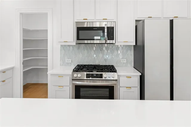 a view of a chandelier fan and entryway