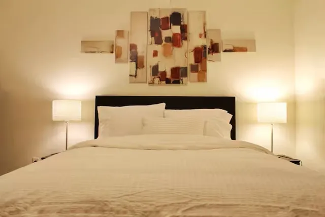 a large white bed in a white room