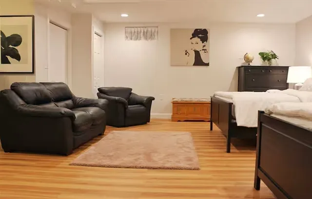 a living room with furniture and wooden floor