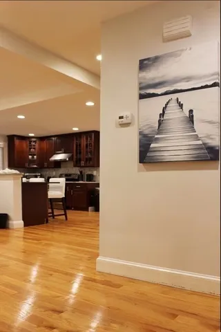 a kitchen with stainless steel appliances kitchen island granite countertop a refrigerator and a stove