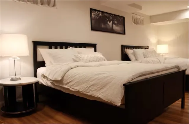 a bedroom with double bed and a night stand