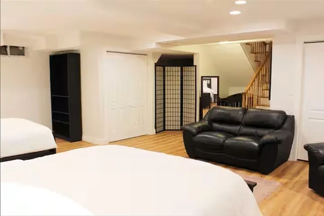 a bedroom with a bed window and couch