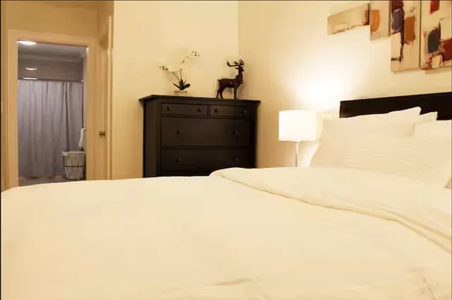 a bedroom with a bed and cabinets