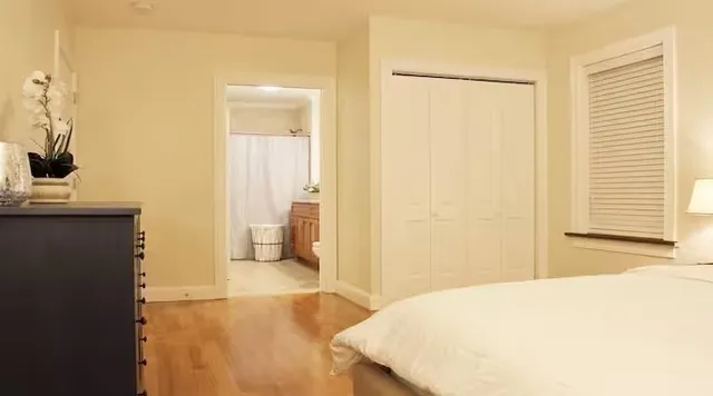 a bedroom with a bed and a chair